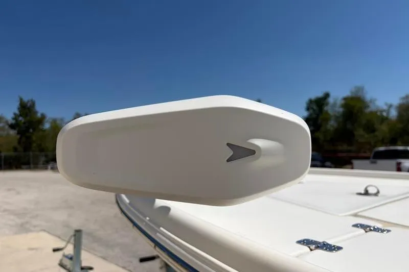 Slide: The Image of 2024 Key West 210 Bay Reef boat detail with clear blue sky background. - 11