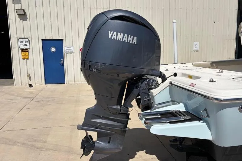 Slide: The Image of 2024 Key West 210 Bay Reef boat with Yamaha outboard motor in a marina setting. - 15