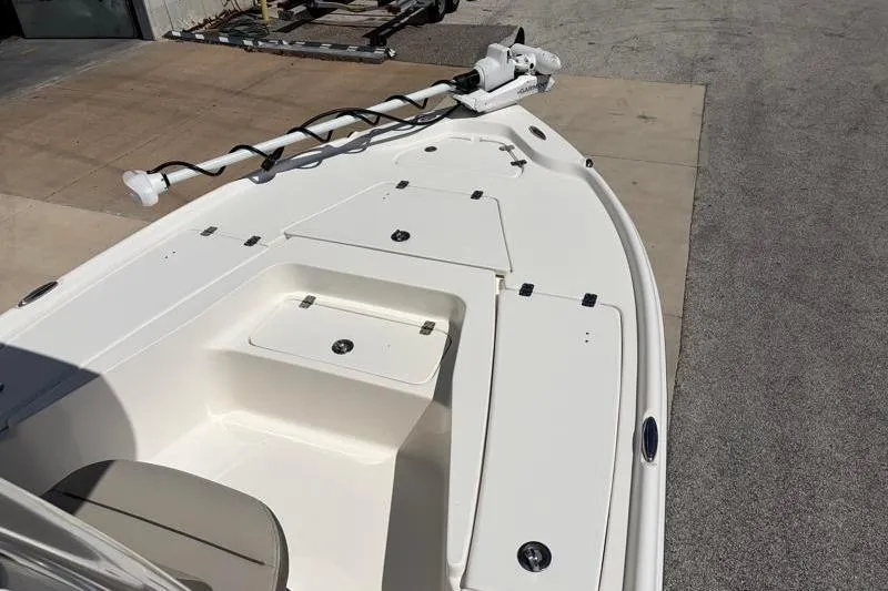 Slide: The Image of 2024 Key West 210 Bay Reef boat deck with storage compartments and trolling motor. - 18