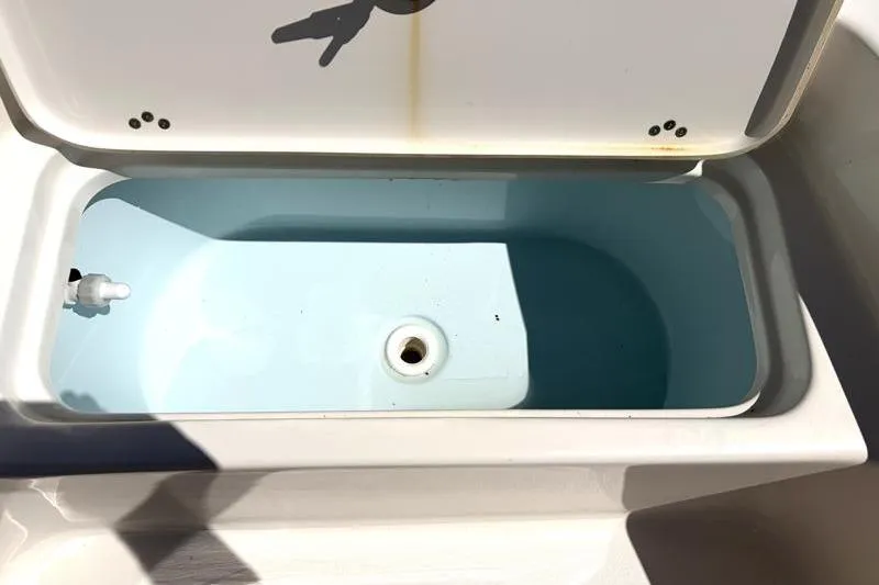 Slide: The Image of Open storage compartment on 2024 Key West 210 Bay Reef boat, showing interior details. - 21