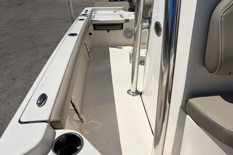 Slide: The Image of 2024 Key West 210 Bay Reef boat interior with seating and stainless steel fixtures. - 26