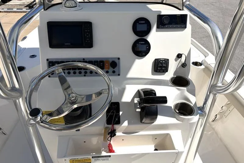 Slide: The Image of 2024 Key West 210 Bay Reef boat console with steering wheel and navigation controls. - 28