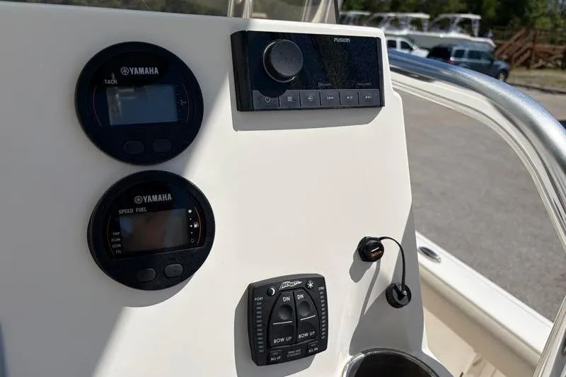 Slide: The Image of 2024 Key West 210 Bay Reef dashboard with Yamaha gauges and Fusion audio controls. - 30