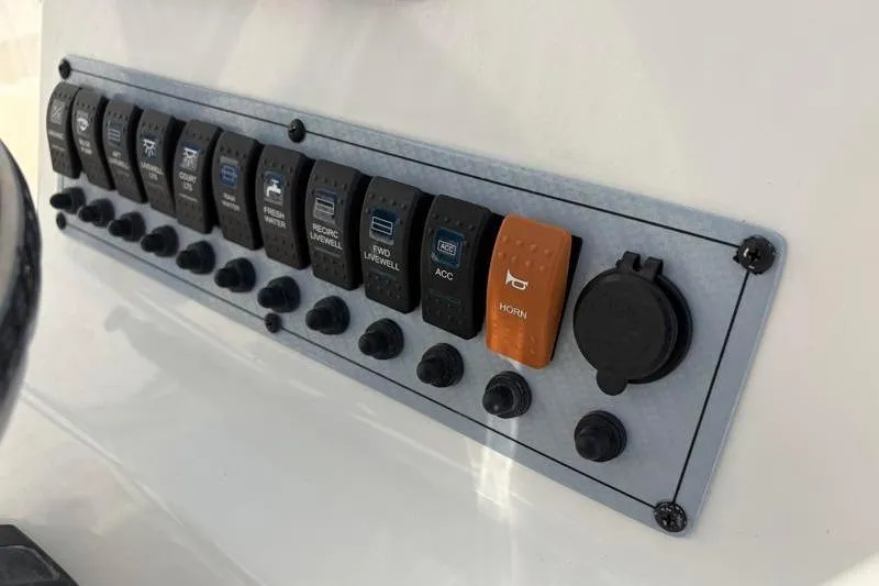 Slide: The Image of 2024 Key West 210 Bay Reef control panel with switches and horn button. - 31