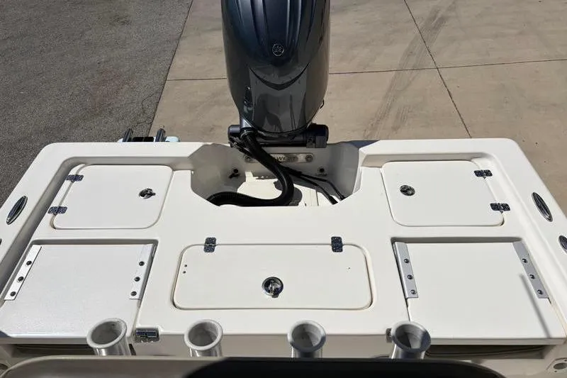 Slide: The Image of 2024 Key West 210 Bay Reef boat deck with motor and storage compartments. - 35
