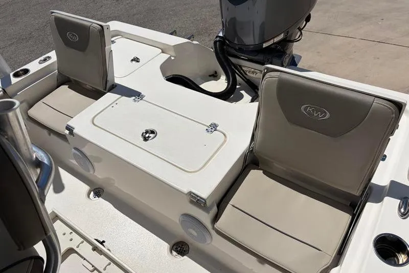 Slide: The Image of 2024 Key West 210 Bay Reef boat interior with cushioned seating and storage compartments. - 36