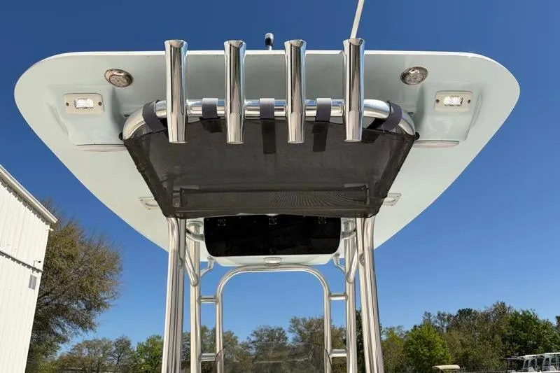 Slide: The Image of 2024 Key West 210 Bay Reef boat T-top with rod holders against blue sky. - 39