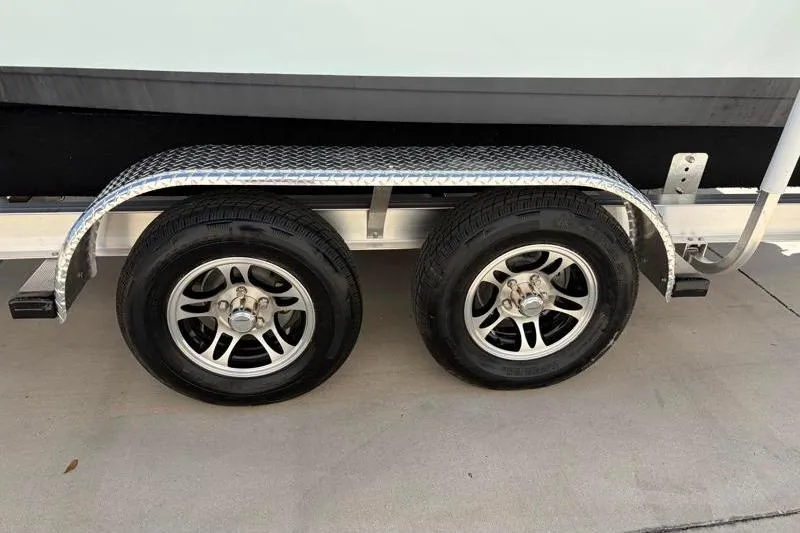 Slide: The Image of 2024 Key West 210 Bay Reef trailer with dual wheels and metal fender. - 42