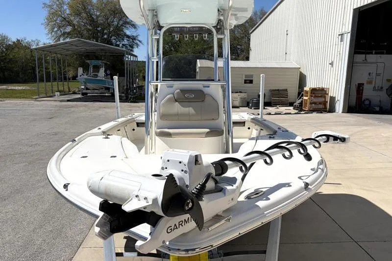 Slide: The Image of 2024 Key West 210 Bay Reef boat with Garmin trolling motor, parked outdoors. - 6