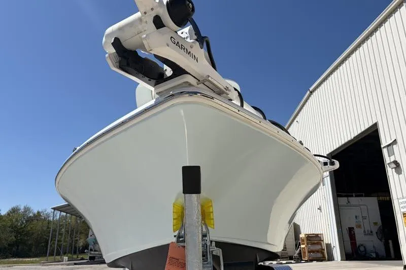 Slide: The Image of 2024 Key West 210 Bay Reef boat with Garmin equipment, parked outside a warehouse. - 7