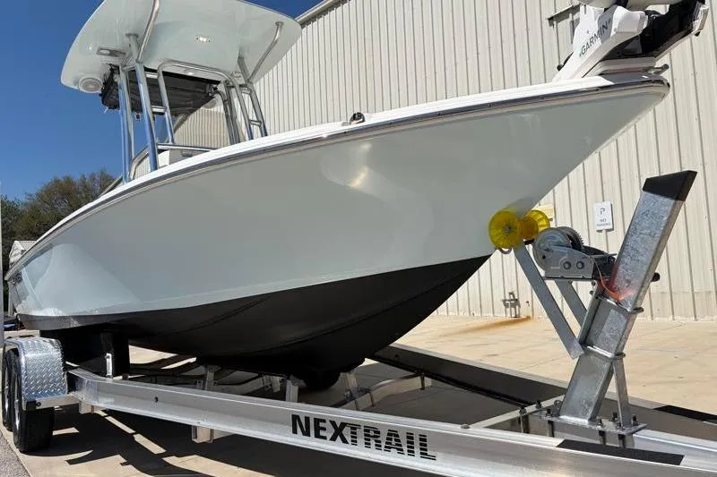 Slide: The Image of 2024 Key West 210 Bay Reef boat on Nextrail trailer, parked outdoors. - 8
