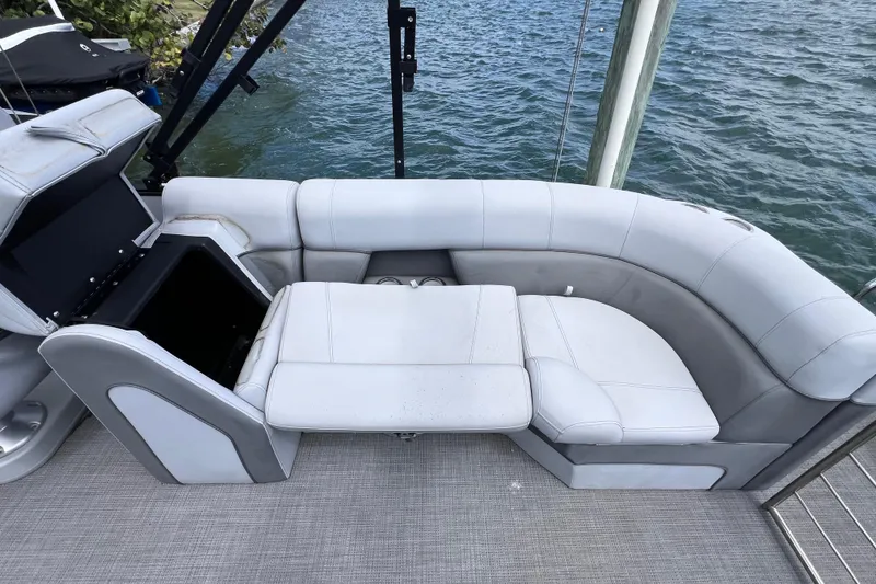 Slide: The Image of Luxurious seating on 2023 Bentley Pontoons 250 Elite Admiral, overlooking serene water. - 15