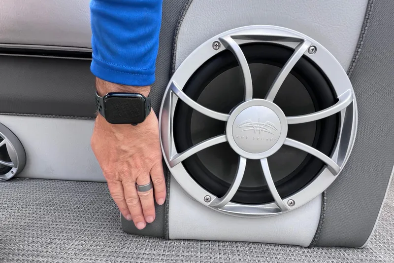 Slide: The Image of Hand touching speaker on 2023 Bentley Pontoons 250 Elite Admiral boat interior. - 19