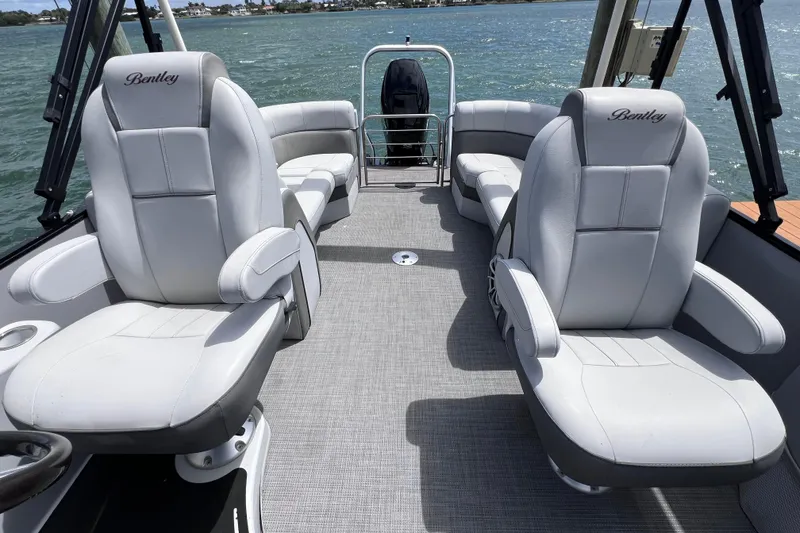 Slide: The Image of 2023 Bentley Pontoons 250 Elite Admiral interior with luxurious seating on a sunny day. - 22