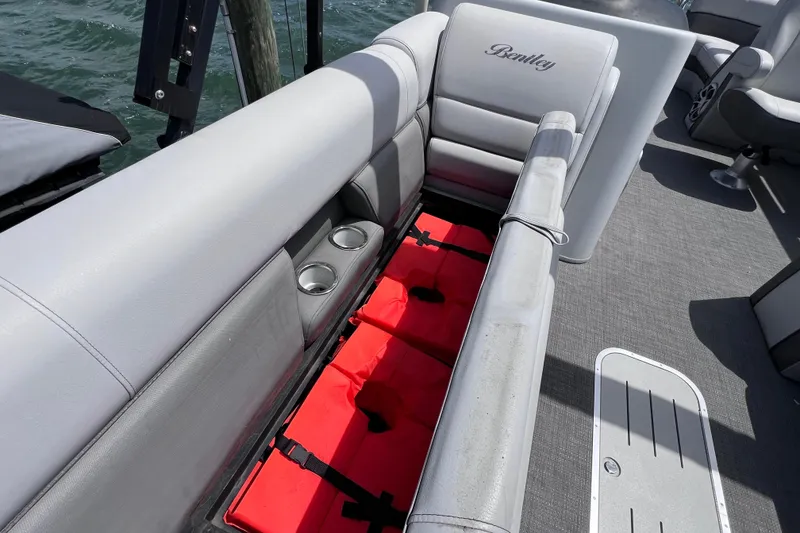 Slide: The Image of 2023 Bentley Pontoons 250 Elite Admiral with open seat storage and cup holders. - 27