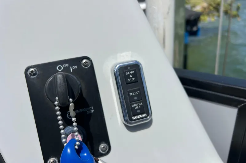 Slide: The Image of Control panel of a 2023 Bentley Pontoons 250 Elite Admiral with Suzuki start-stop button. - 33
