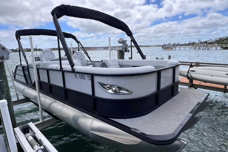 Slide: The Image of 2023 Bentley Pontoons 250 Elite Admiral on water, showcasing luxury design and spacious seating. - 4