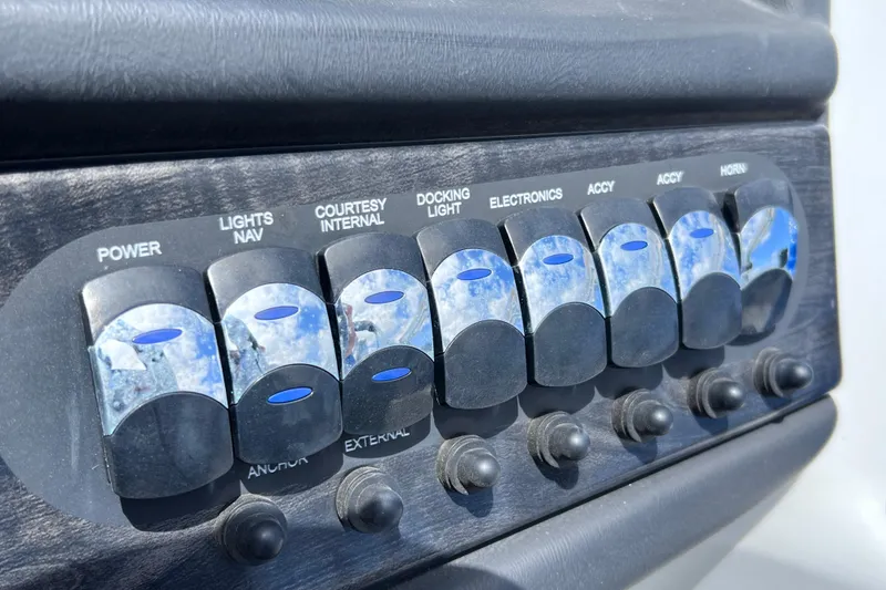 Slide: The Image of Control panel of 2023 Bentley Pontoons 250 Elite Admiral with labeled switches. - 41