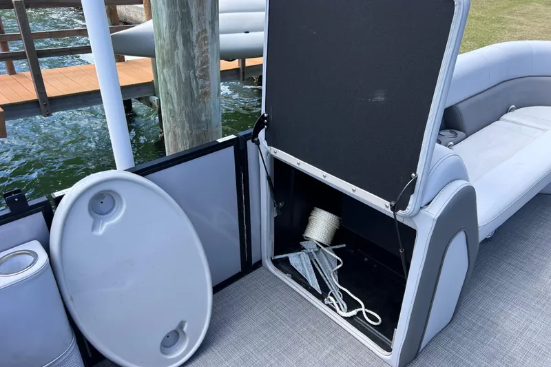 Slide: The Image of 2023 Bentley Pontoons 250 Elite Admiral storage compartment with rope and anchor. - 42