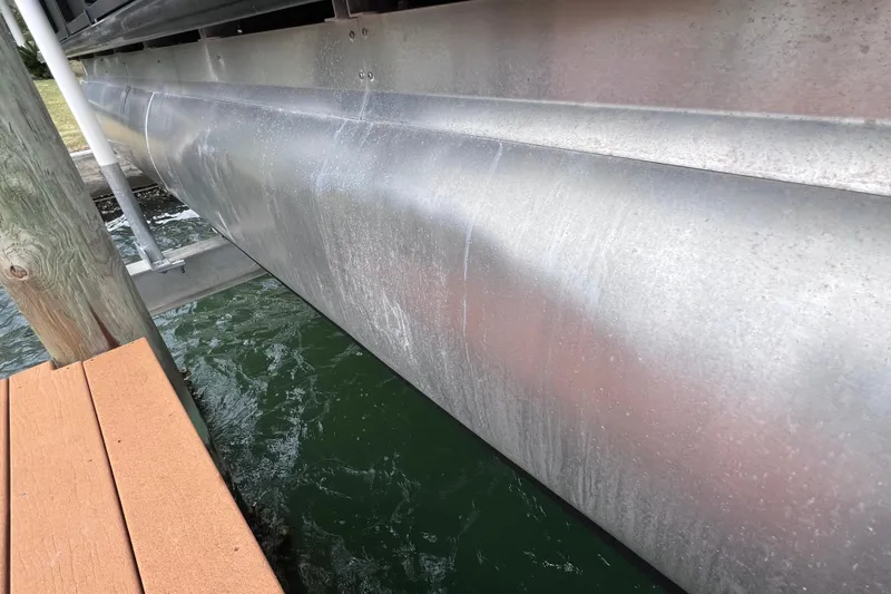 Slide: The Image of Close-up of 2023 Bentley Pontoons 250 Elite Admiral pontoon hull near dock. - 52