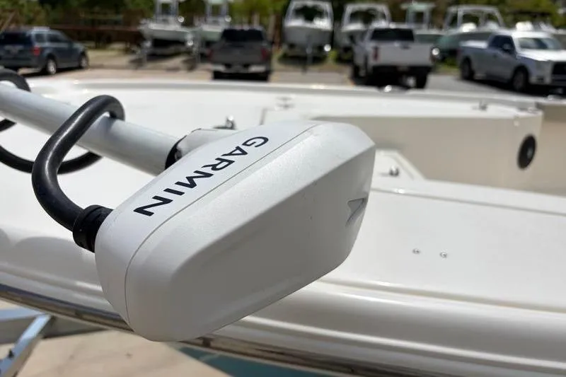 Slide: The Image of Garmin device on 2025 Key West 210 Bay Reef boat, parked with trucks in background. - 11