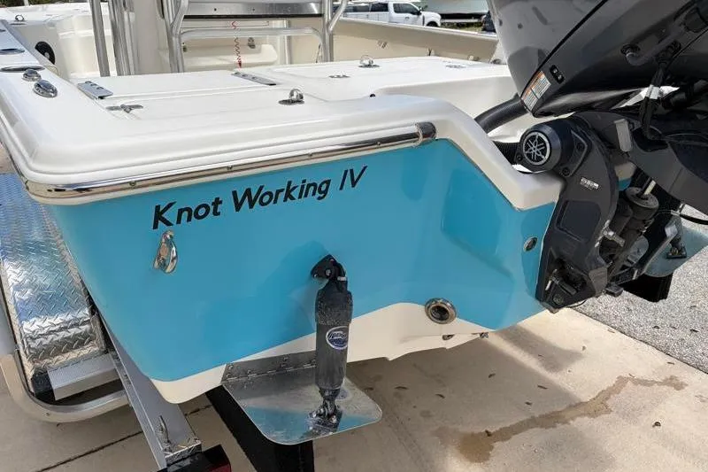 Slide: The Image of 2025 Key West 210 Bay Reef boat with "Knot Working IV" name, featuring a Yamaha outboard motor. - 13
