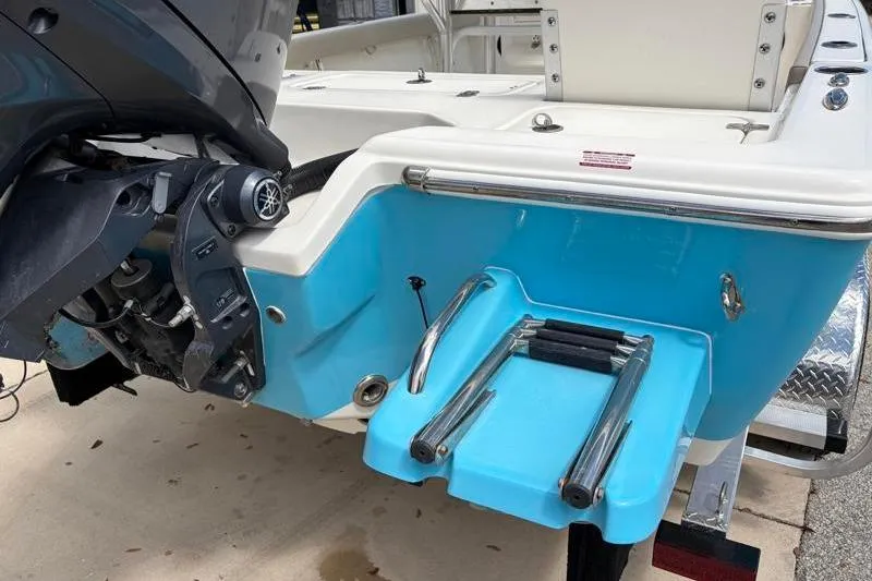 Slide: The Image of 2025 Key West 210 Bay Reef boat with outboard motor and swim ladder. - 14