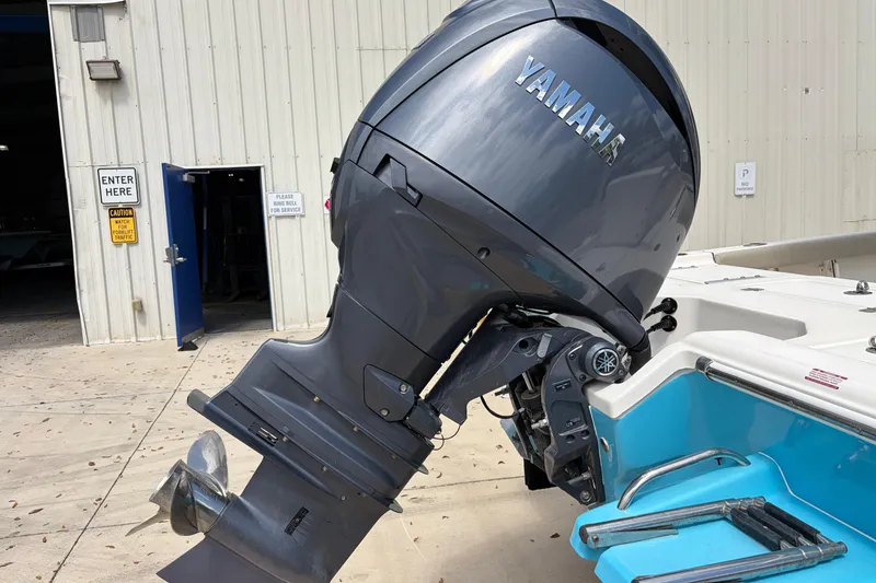Slide: The Image of 2025 Key West 210 Bay Reef boat with Yamaha outboard motor at a service facility. - 15