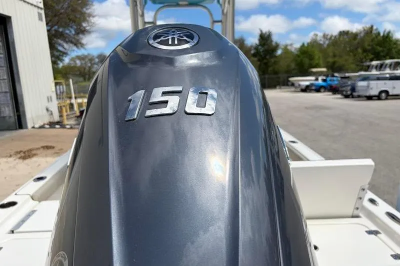Slide: The Image of 2025 Key West 210 Bay Reef boat with Yamaha 150 outboard motor in a sunny outdoor setting. - 16