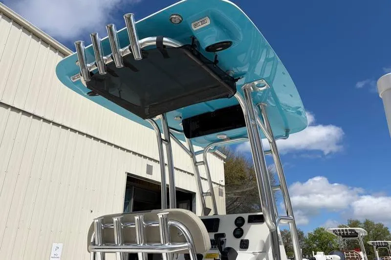 Slide: The Image of 2025 Key West 210 Bay Reef boat with blue T-top and rod holders. - 18