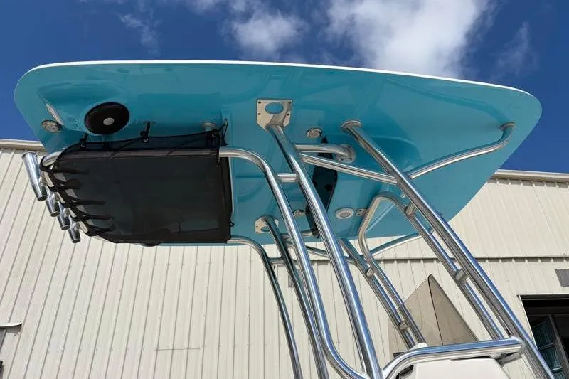Slide: The Image of T-top of 2025 Key West 210 Bay Reef boat with blue underside and stainless steel supports. - 19
