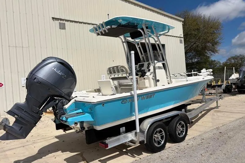 Slide: The Image of 2025 Key West 210 Bay Reef boat on trailer, featuring Yamaha outboard motor. - 2