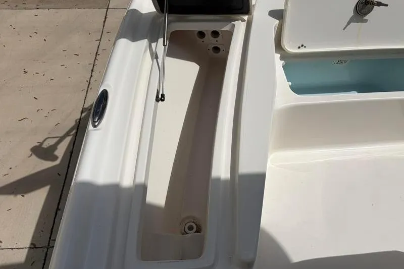Slide: The Image of Key West 210 Bay Reef 2025 boat deck with storage compartment and open hatch. - 24