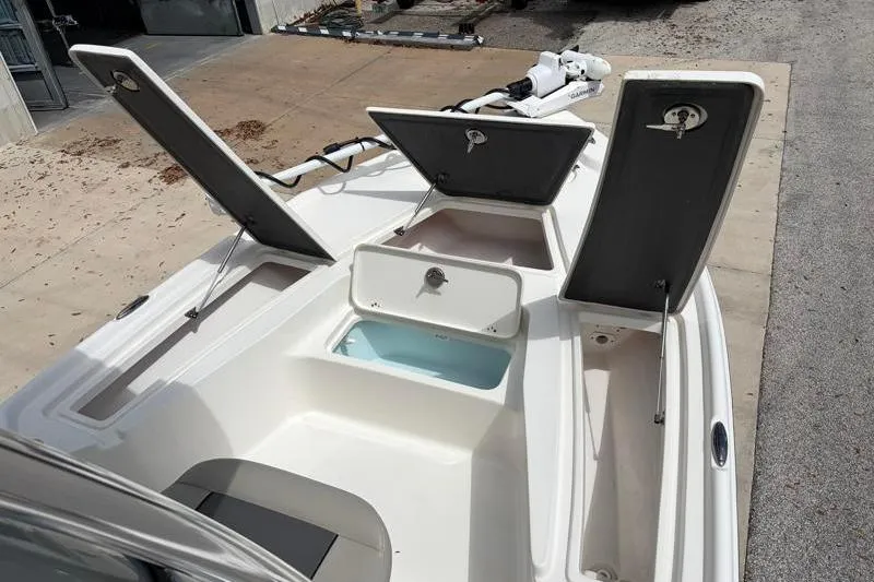 Slide: The Image of 2025 Key West 210 Bay Reef boat with open storage compartments on deck. - 26
