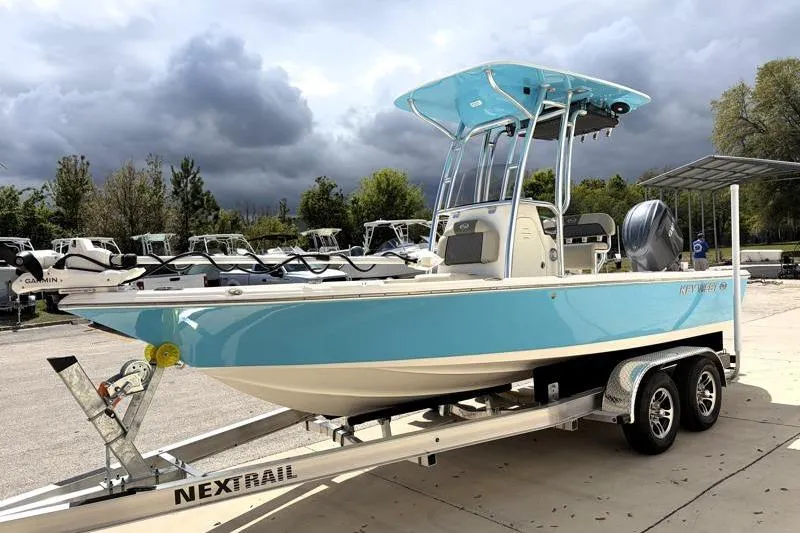 Slide: The Image of 2025 Key West 210 Bay Reef boat on trailer, under cloudy sky. - 3