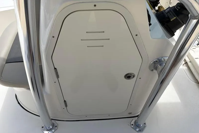 Slide: The Image of 2025 Key West 210 Bay Reef boat console with storage compartment and chrome railings. - 31