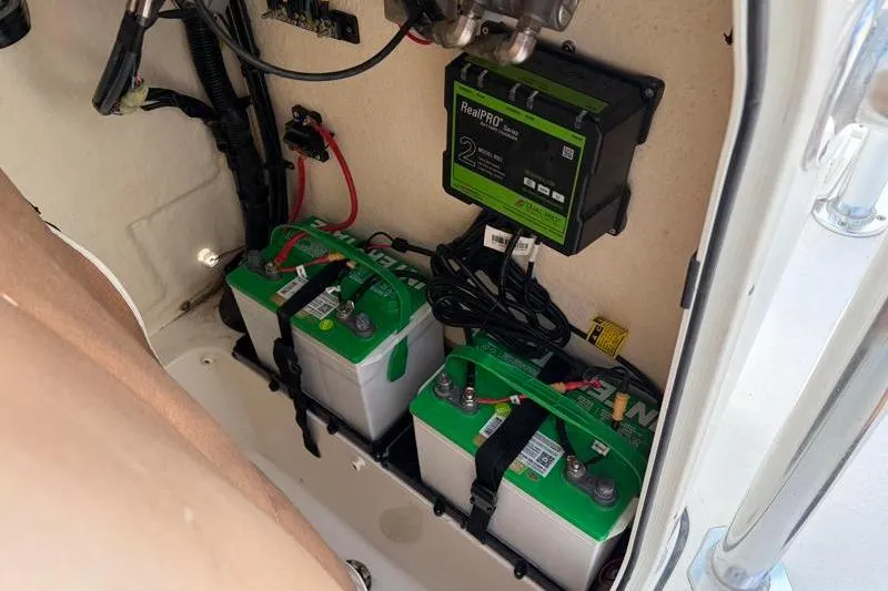 Slide: The Image of Battery compartment of 2025 Key West 210 Bay Reef boat with charger and wiring. - 33