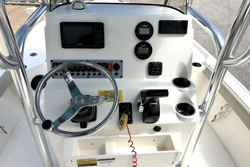 Slide: The Image of Center console of 2025 Key West 210 Bay Reef boat with steering wheel and controls. - 35