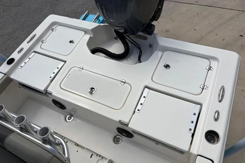 Slide: The Image of 2025 Key West 210 Bay Reef boat deck with storage compartments and motor. - 41