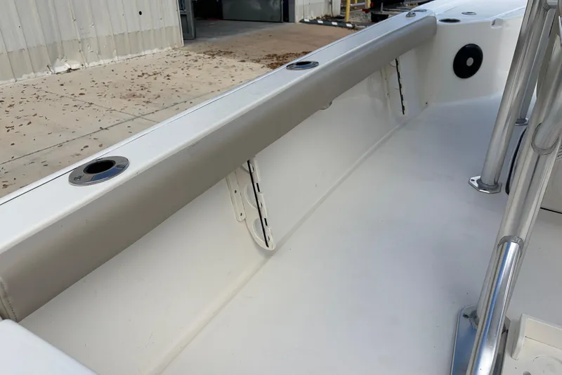 Slide: The Image of 2025 Key West 210 Bay Reef boat interior with rod holders and stainless steel railing. - 47