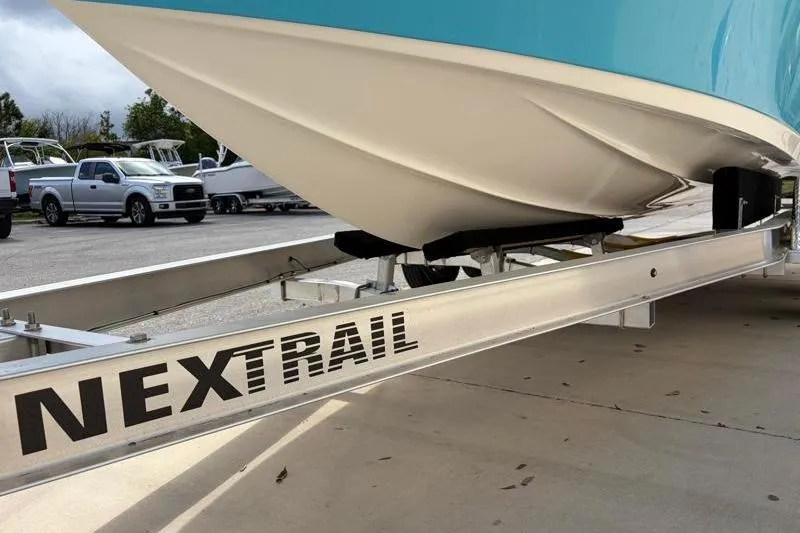 Slide: The Image of 2025 Key West 210 Bay Reef boat on NexTrail trailer, parked outdoors. - 49