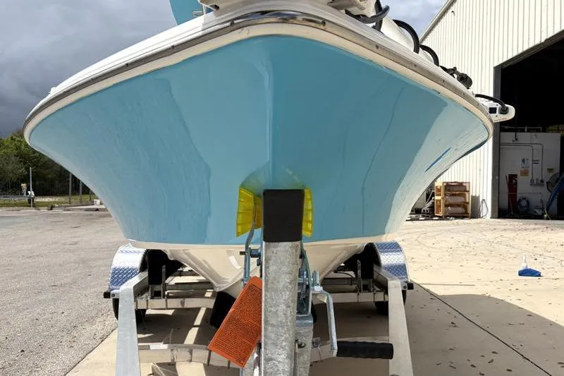 Slide: The Image of 2025 Key West 210 Bay Reef boat on trailer, parked outside a building. - 7