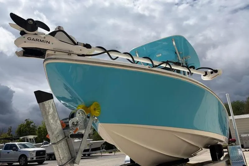 Slide: The Image of 2025 Key West 210 Bay Reef boat with Garmin equipment, displayed on a trailer under cloudy skies. - 9