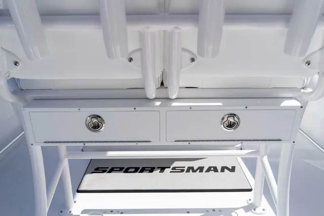 Slide: The Image of Sportsman Open 232 Center Console 2026, white drawers and logo. - 15