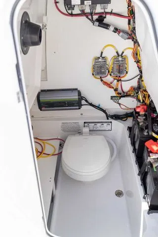 Slide: The Image of Interior of Sportsman Open 232 Center Console 2026 with electronics and toilet. - 22