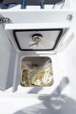 Slide: The Image of Storage compartment in Sportsman Open 232 Center Console 2026 with rope. - 30