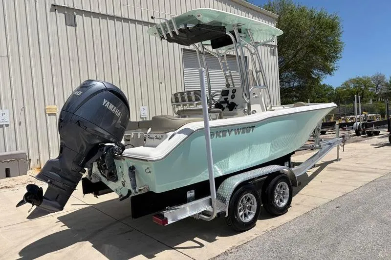 Slide: The Image of 2024 Key West 203 FS boat on trailer with Yamaha outboard motor, parked outdoors. - 3