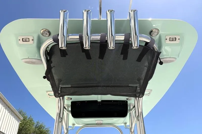 Slide: The Image of 2024 Key West 203 FS boat T-top with rod holders and speakers under clear sky. - 37