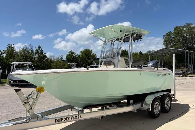 Slide: The Image of 2024 Key West 203 FS boat on trailer under blue sky. - 4