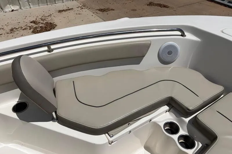 Slide: The Image of 2024 Key West 203 FS boat interior with cushioned seating and cup holders. - 20